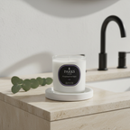 Parks candle on a bathroom counter with a sink and faucet in the background
