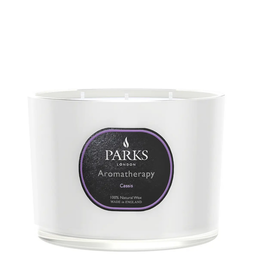 White candle with a black label featuring the 'Parks London' brand on a white background