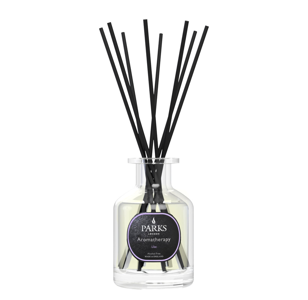 Diffuser with black sticks and a visible label on a white background