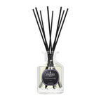 Diffuser with black sticks and a visible label on a white background