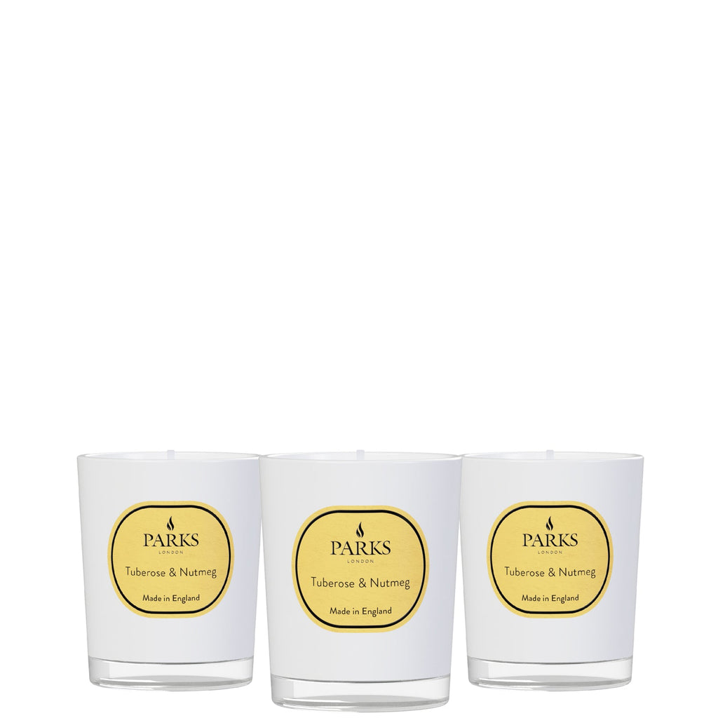 Three white candles with yellow 'Parks' labels on a white background