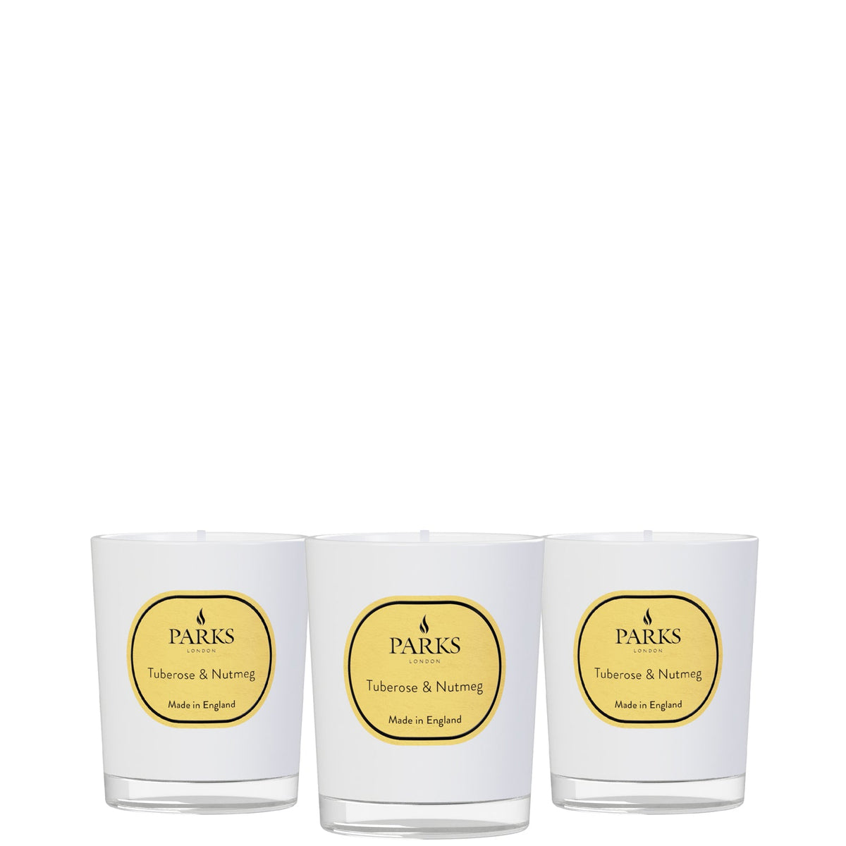 Three white candles with yellow 'Parks' labels on a white background