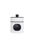 White candle with black lid and label on a white background