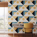 Modern interior with geometric patterned wall, desk, and chair.