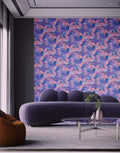 Modern living room with a purple sofa and abstract patterned wall.