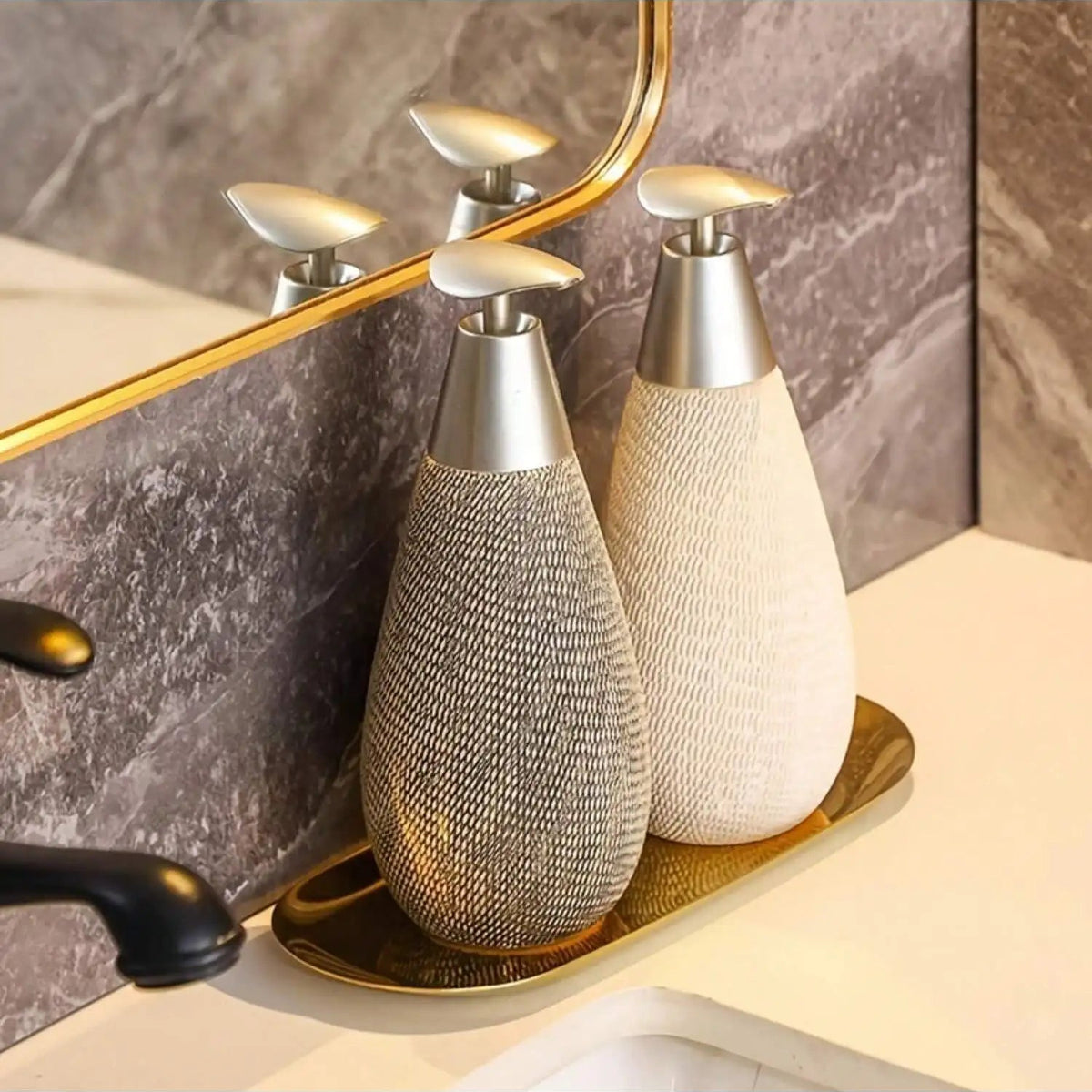 Two decorative bottles on a tray with a mirror and bathroom setting in the background