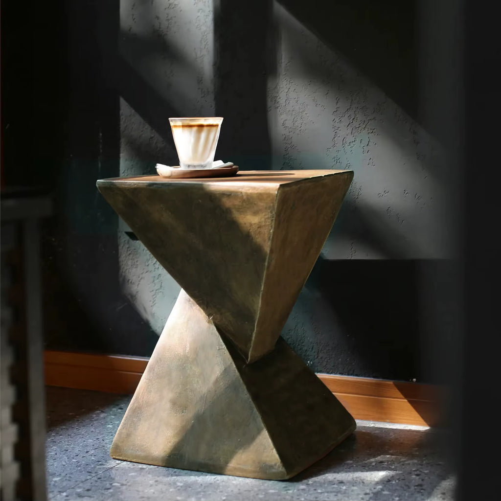 Concrete side table with a cup of coffee on a dark background