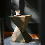 Concrete side table with a cup of coffee on a dark background
