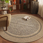 Round woven rug in a living room setting with a chair and books.
