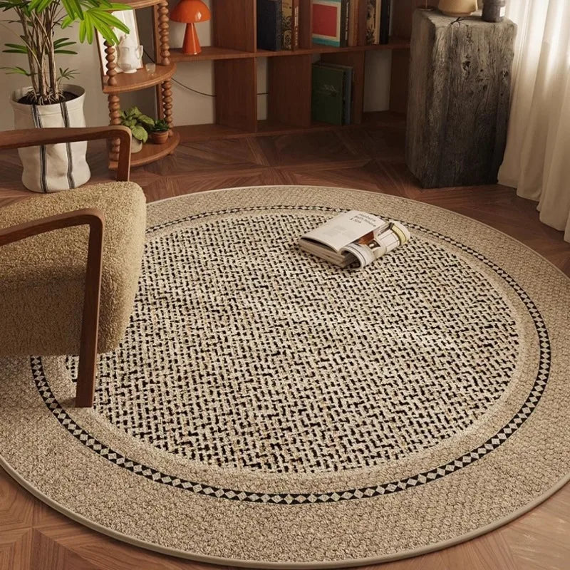 Round woven rug in a living room setting with a chair and books.