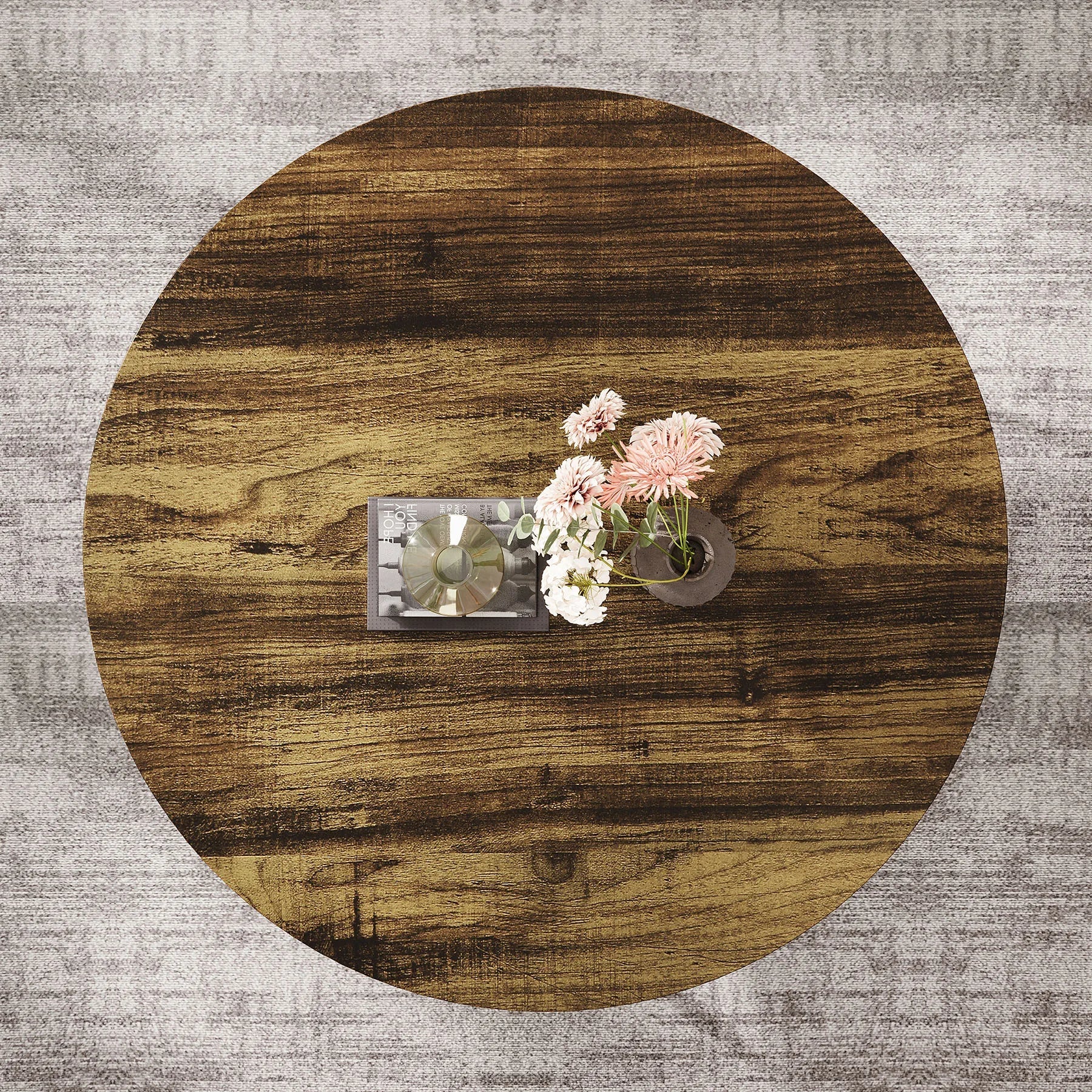 Round wooden table with decorative items on a textured gray surface