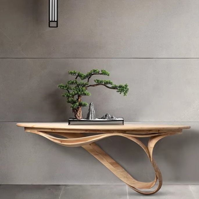 Wooden console table with a bonsai tree against a gray wall