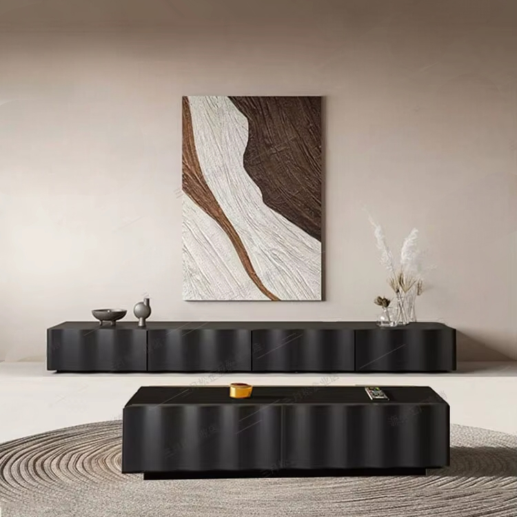 Modern living room with black furniture and abstract wall art