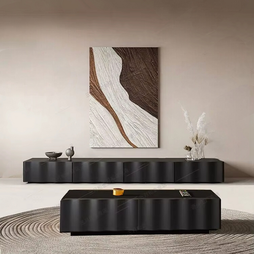 Modern living room with black furniture and abstract wall art