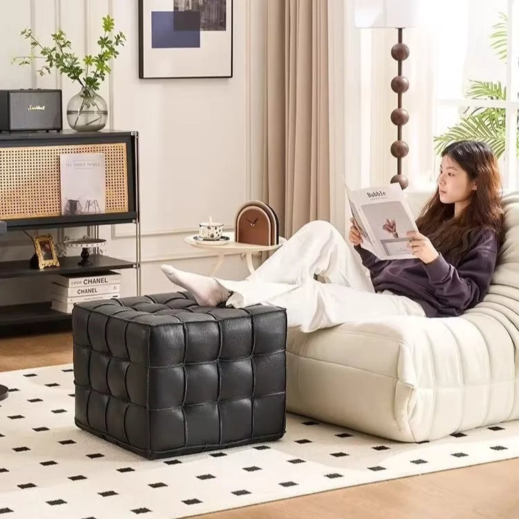 Woman reading a magazine on a white sofa in a stylish living room.