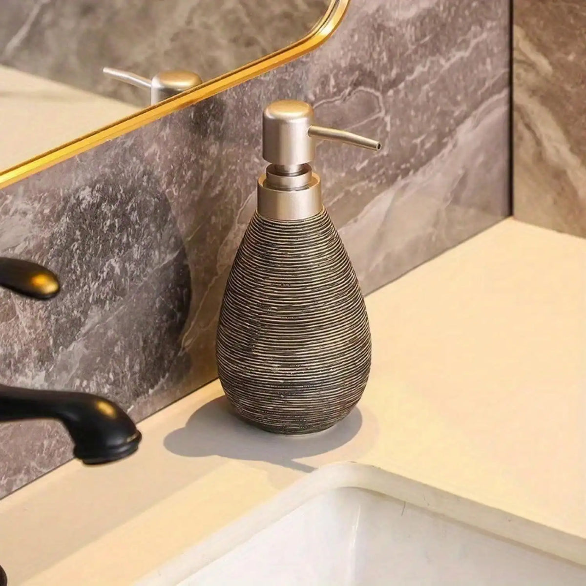 Decorative soap dispenser on a bathroom counter with marble wall and sink in the background
