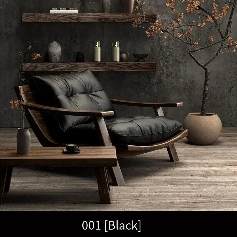 Modern black leather armchair in a darkly decorated room with wooden shelves and decor.