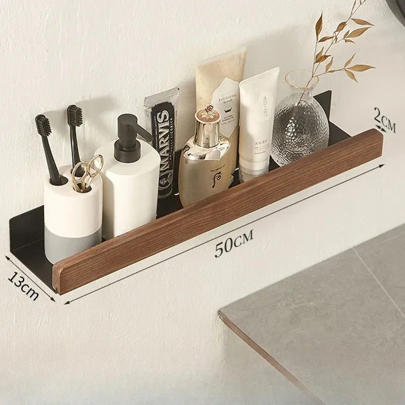 Wooden shelf with bathroom products on a white wall