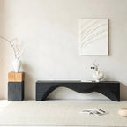 Modern living room with a black console table, decorative vases, and abstract wall art.