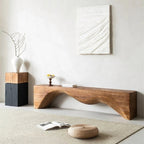 Modern wooden console table in a minimalistic room with abstract art and decor items.