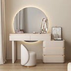 Modern vanity setup with round mirror, desk, and chair in a well-lit room.