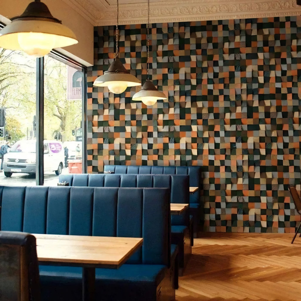 Restaurant interior with blue booths and a patterned wall.