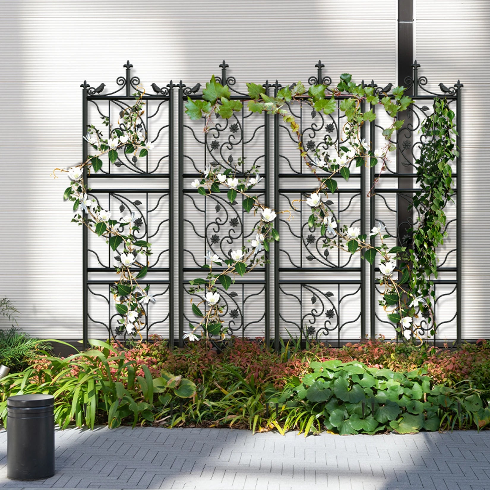 Decorative metal trellis with climbing plants against a white wall