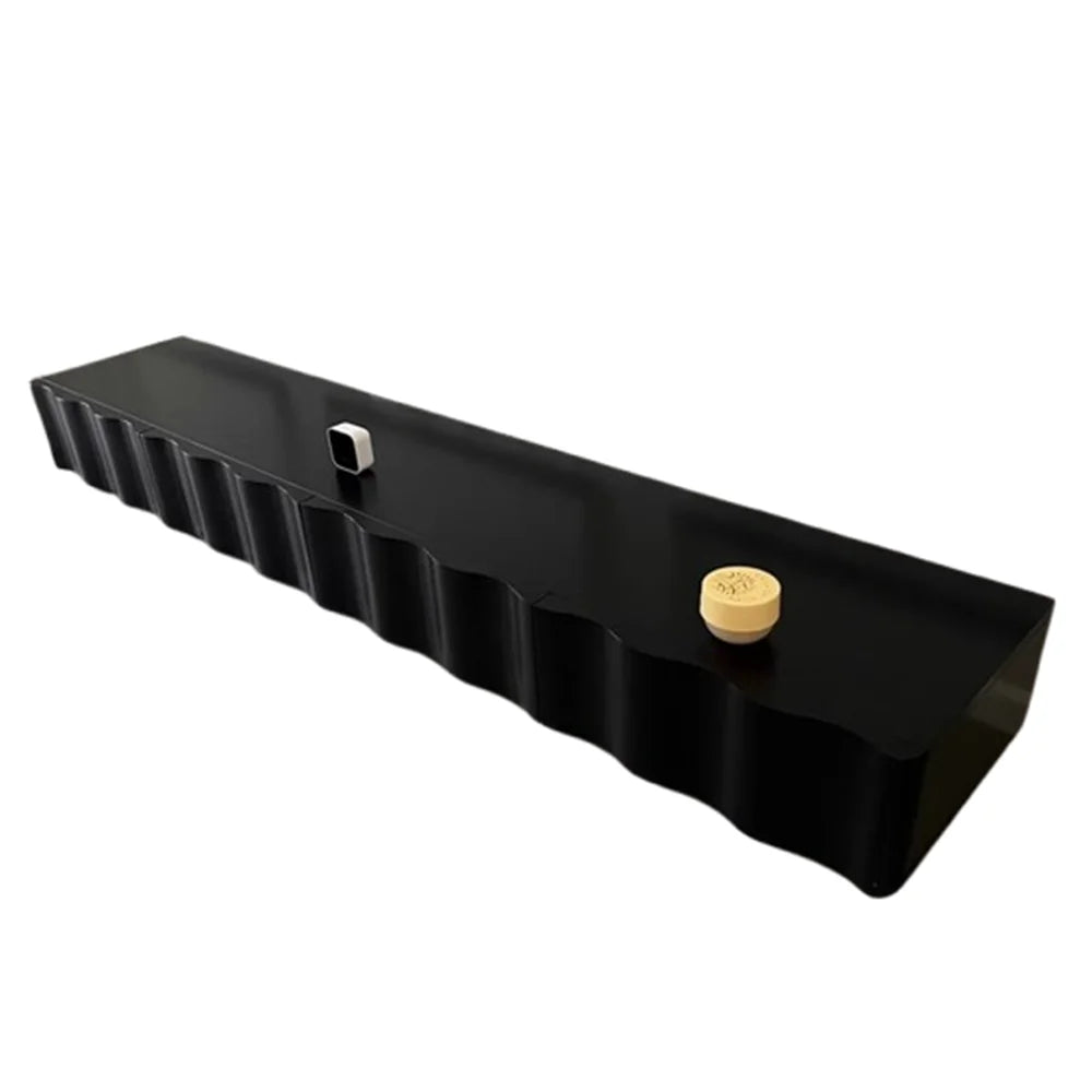 Black rectangular object with a gold knob on a white background