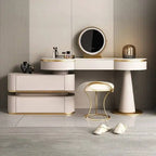 Modern vanity table with mirror, stool, and decorative items in a stylish room.