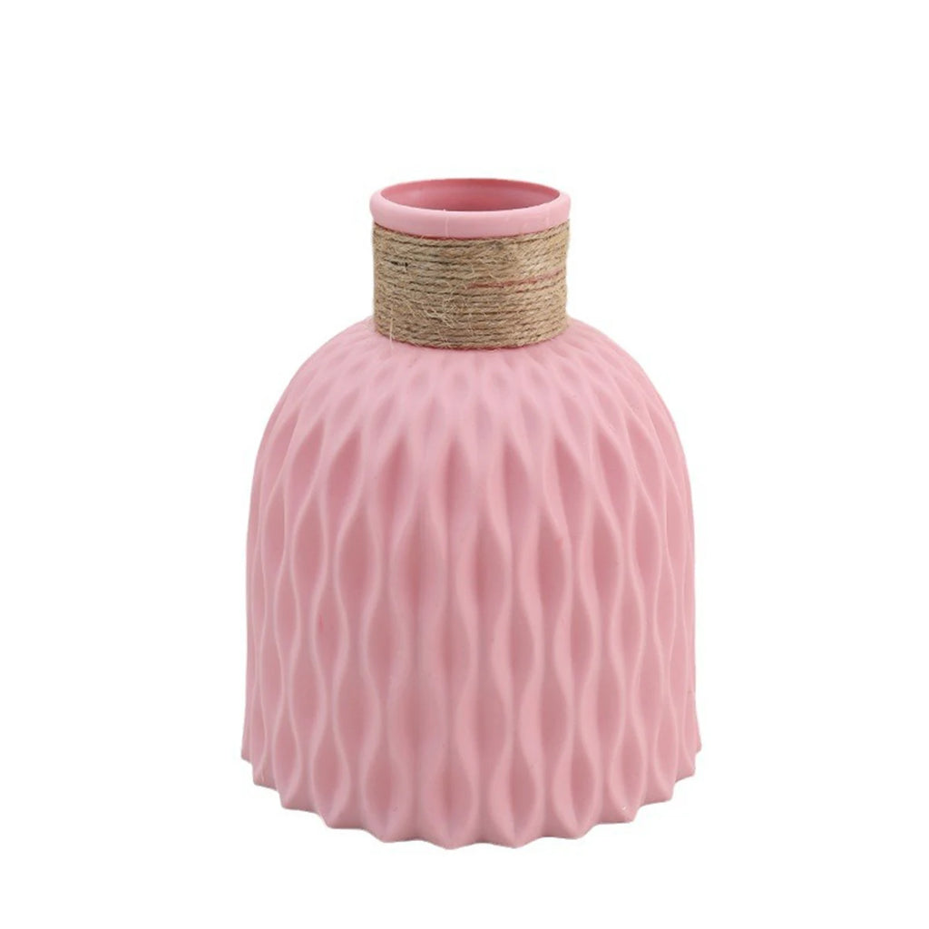 Pink textured vase with a natural rope handle on a white background
