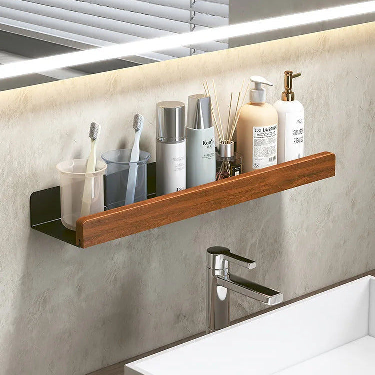 Bathroom shelf with toiletries against a mirror with LED lighting