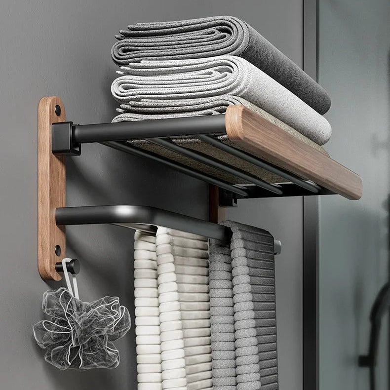 Bathroom storage solution with a towel rack holding folded towels against a gray wall.