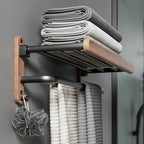 Bathroom storage solution with a towel rack holding folded towels against a gray wall.