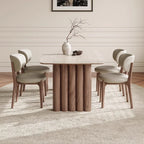 Dining room with a wooden table and chairs on a carpeted floor.