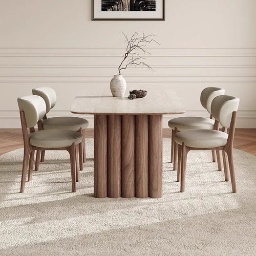 Dining room with a wooden table and chairs on a carpeted floor.