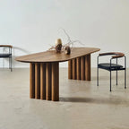 Wooden dining table with modern chairs in a minimalistic setting
