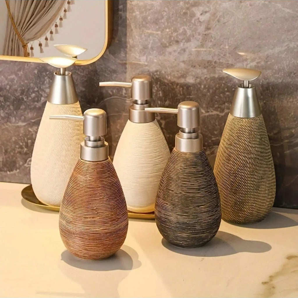 Set of decorative bottles with metallic caps on a marble surface.