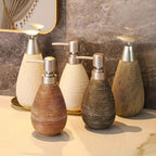 Set of decorative bottles with metallic caps on a marble surface.