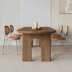 Wooden dining table with four chairs in a modern room setting.
