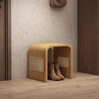 Wooden shoe storage bench with boots underneath in a hallway setting.