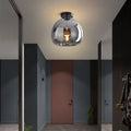 Modern dome semi-flush glass ceiling light with black or gold finish and E27 bulb fitting for stylish interior lighting.
