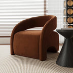 Brown curved armchair in a room with a window and decorative wall piece.
