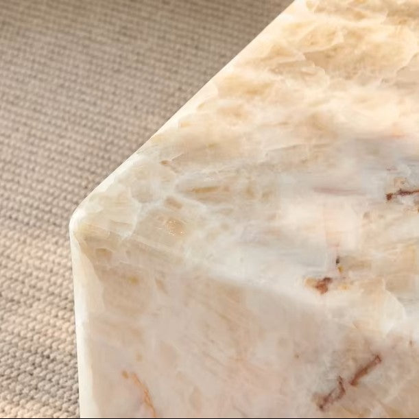 Close-up of a beige stone block with a textured surface