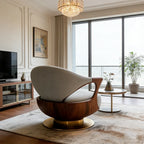 Modern living room with a stylish armchair, television, and large windows.
