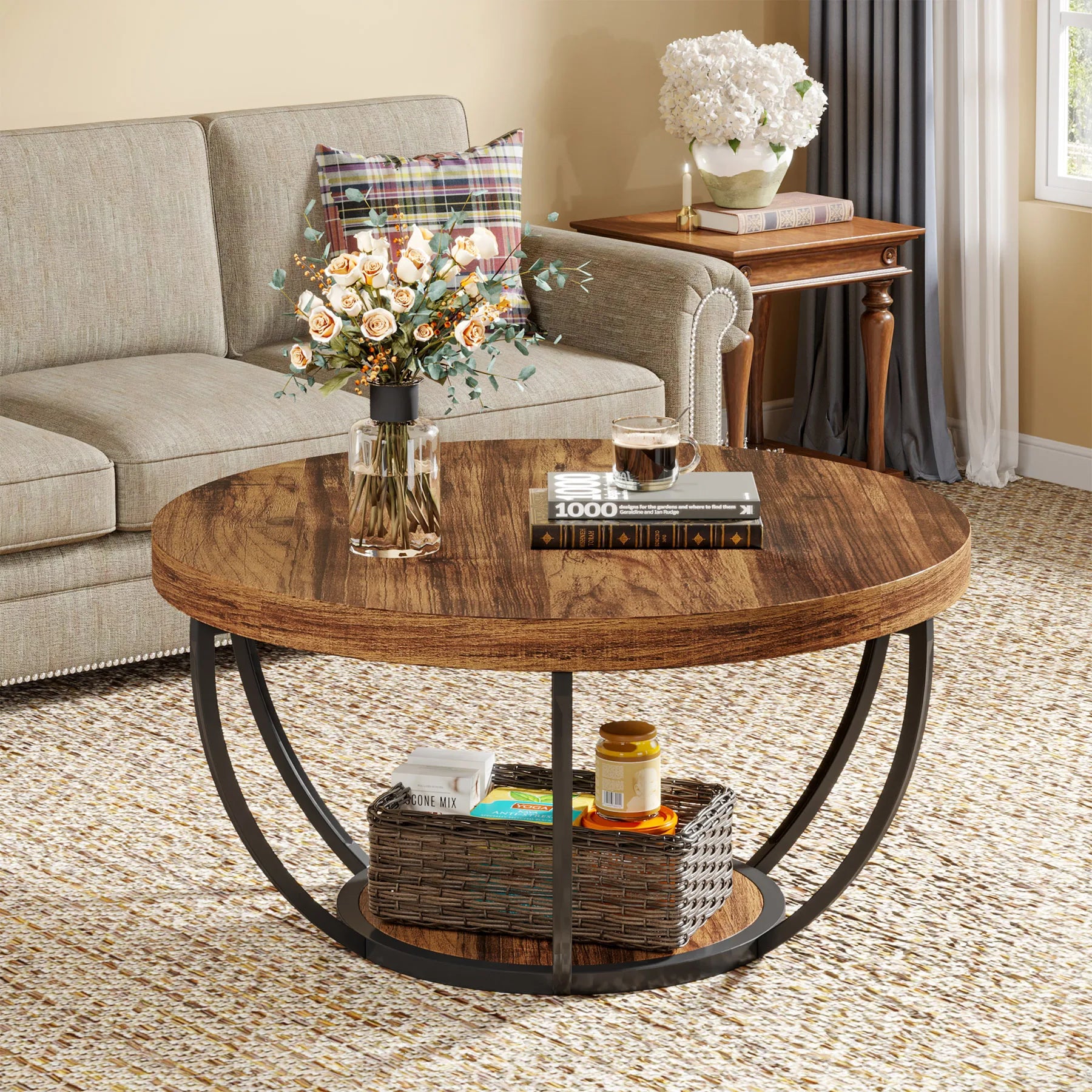 Round wooden coffee table with decorative items in a living room setting.