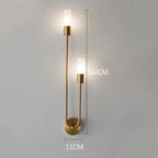 Gold wall sconce with dimensions indicated on a gray background