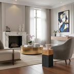Modern living room with marble fireplace, gold coffee table, and abstract art.