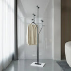 Modern coat stand with a beige coat in a minimalistic room.