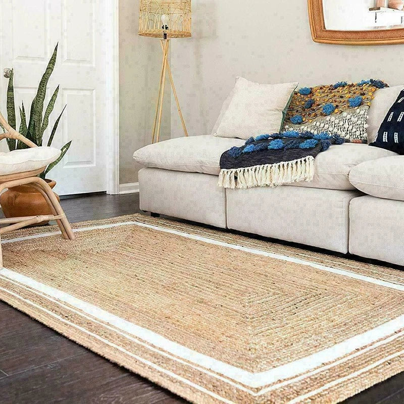 Living room with a beige sofa, decorative pillows, and a jute rug.