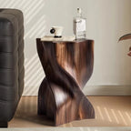 Wooden side table with a bottle and cup on a light-colored floor.